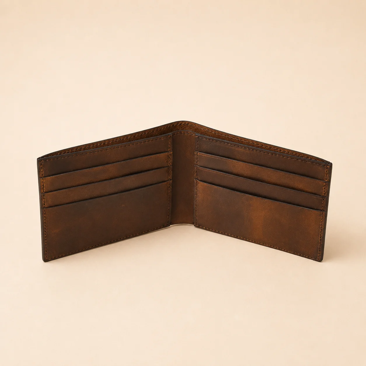 Open brown bifold wallet showing bill pocket and card layout